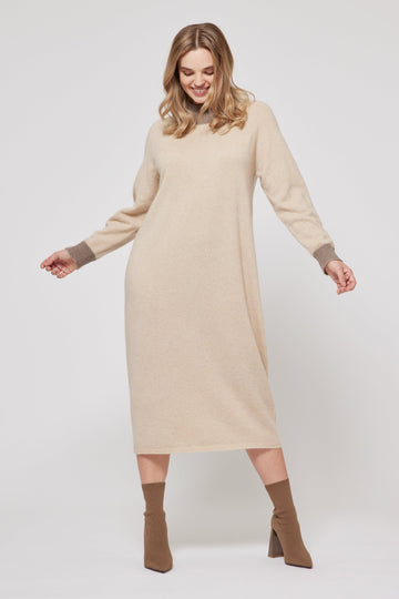 Woman wearing a beige dress with brown socks on a white background